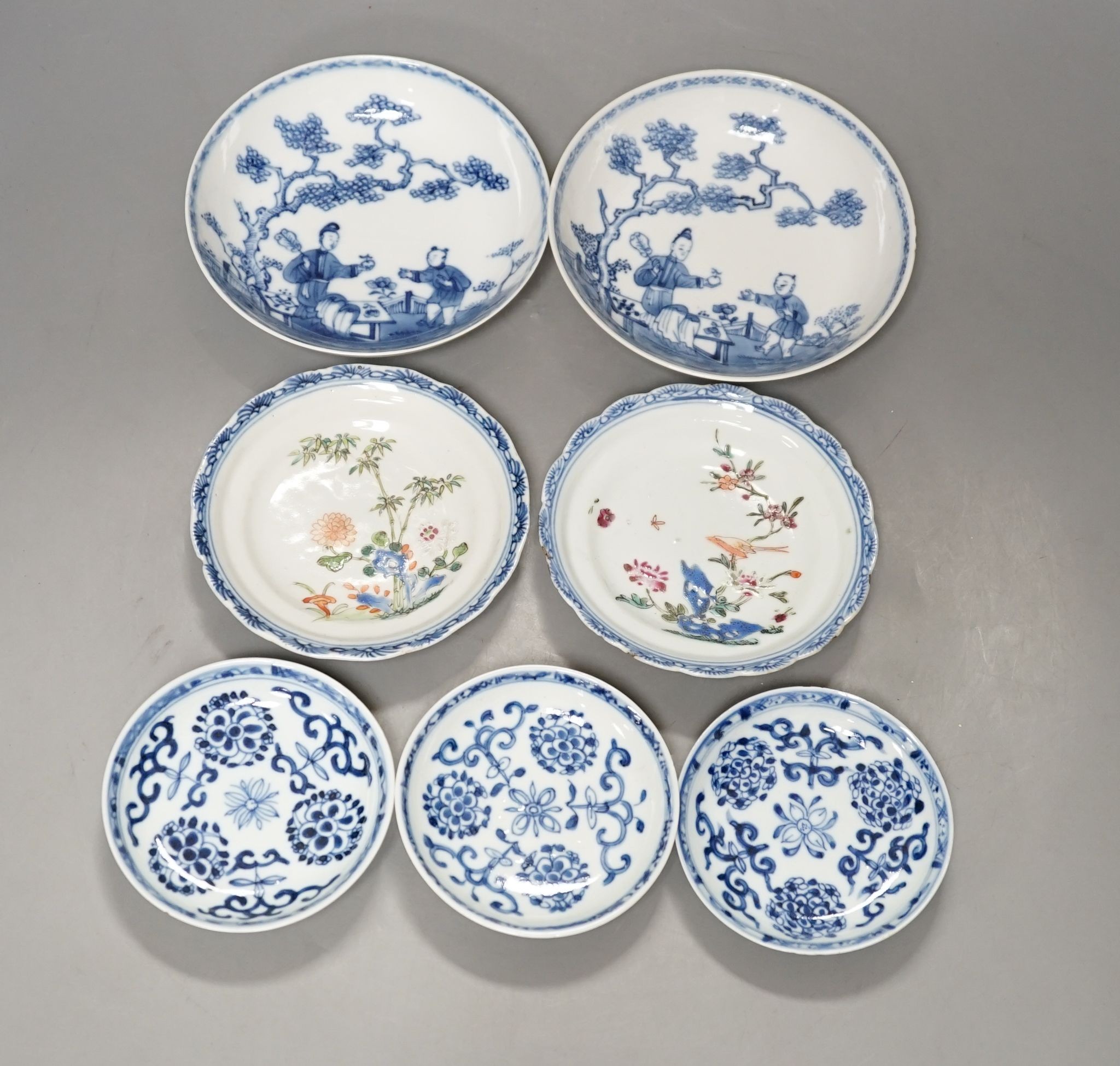 Seven 18th century Chinese saucer dishes, largest 14 cms diameter.